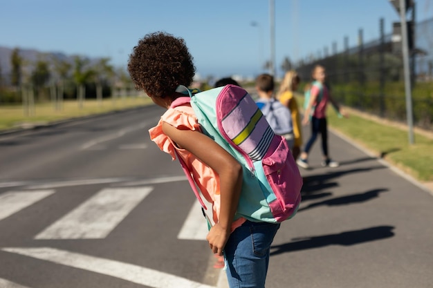Photo Écoliers à la recherche de trafic en attendant de traverser la route