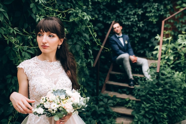 Photo Élégante mariée et le marié posant ensemble à l'extérieur un jour de mariage