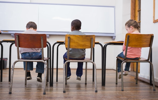 Photo Élèves mignons écoutant attentivement dans la salle de classe