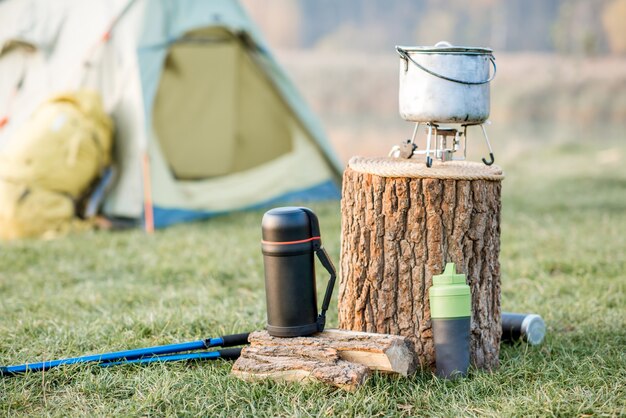 Emplacement de camping avec tente, sac à dos et autres équipements sur la pelouse verte