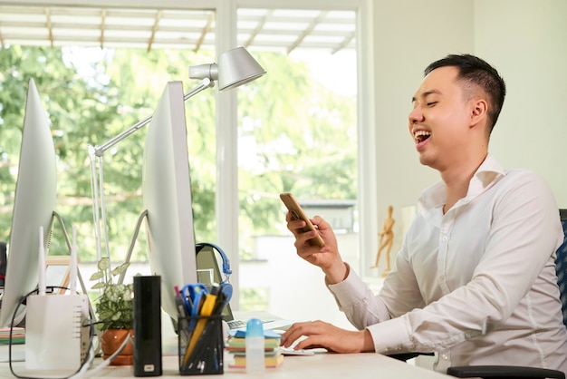 Employé de bureau communiquant en ligne au téléphone