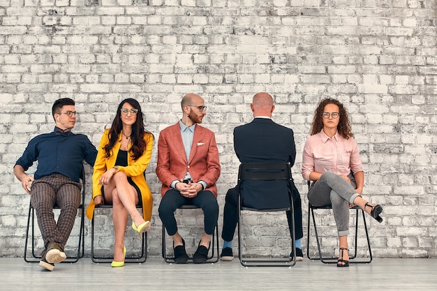 Employés de l'entreprise. Discussion sur les affaires. Équipe solide ignorant un collègue solitaire.