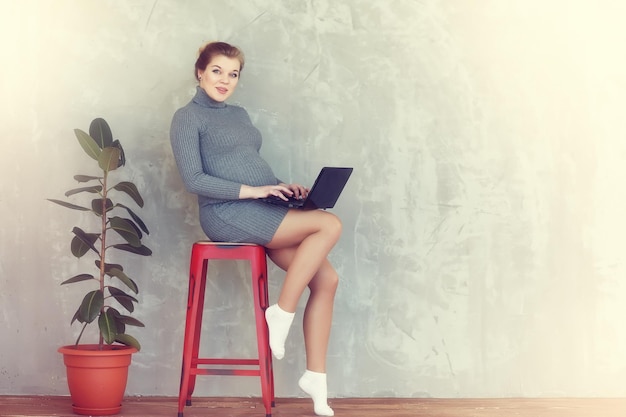 Enceinte jeune et belle fille dans un cadre familial posant