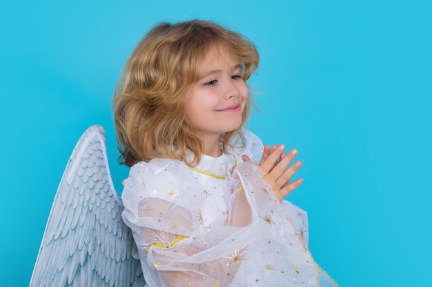 Enfant ange avec des mains de prière espèrent et prient concept isolé studio shot cute kid avec des ailes d'ange c