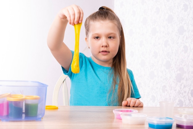 L'enfant aux cheveux blonds joue avec du mucus