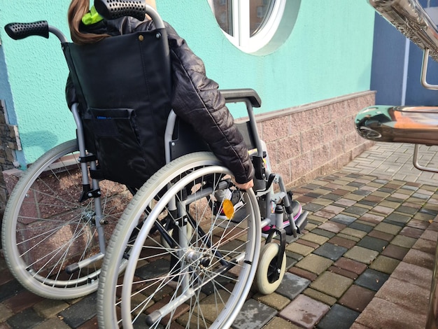 Un enfant ayant des besoins spéciaux en fauteuil roulant apprend à utiliser des fauteuils roulants sur des rampes pour les gens