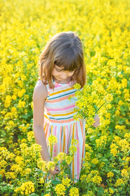 Un enfant dans un champ jaune, la moutarde fleurit