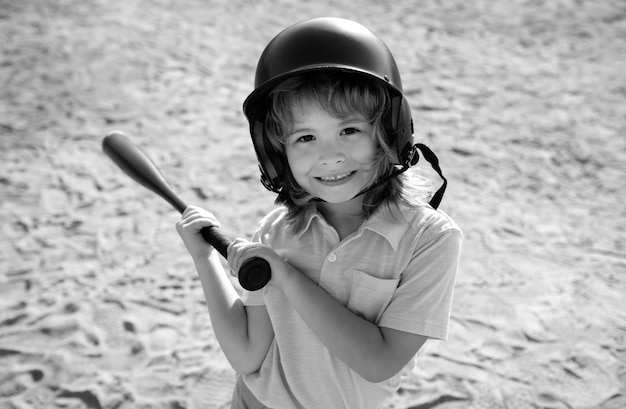 Un enfant drôle à la batte lors d'un match de baseball. Portrait d'enfant en gros plan.