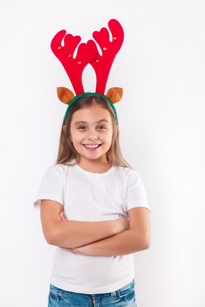 Enfant drôle souriant en cornes de cerf et t-shirt blanc