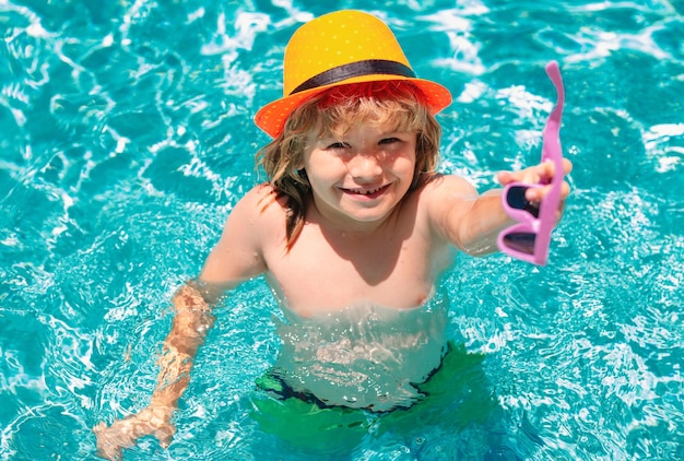 Enfant éclaboussant dans la piscine nager activité sportive nautique pendant les vacances d'été avec de l'eau pour enfants