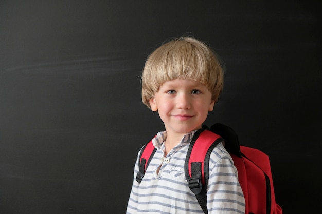 Enfant de l&#39;école primaire avec sac au tableau.