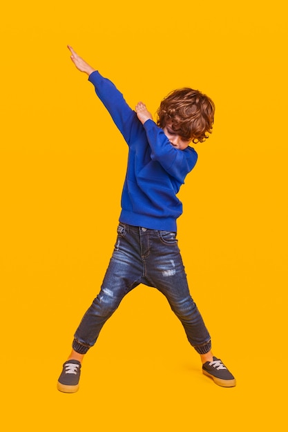 Photo enfant énergique dansant sur jaune