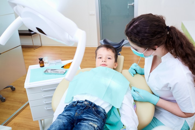 Un enfant enfant et femme dentiste en clinique dentaire