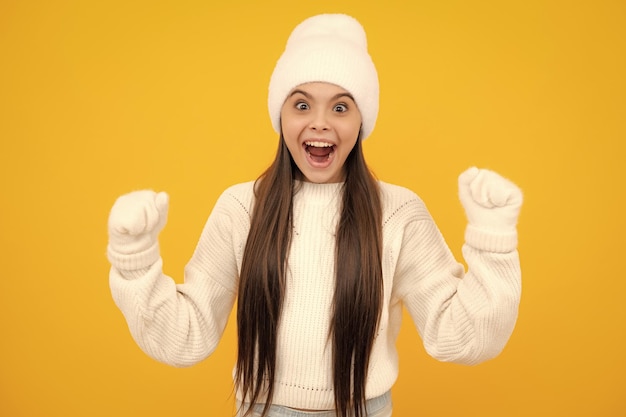 Enfant fille se réjouissant dire oui à l'air heureux et célébrant la victoire champion geste poing pompe sur