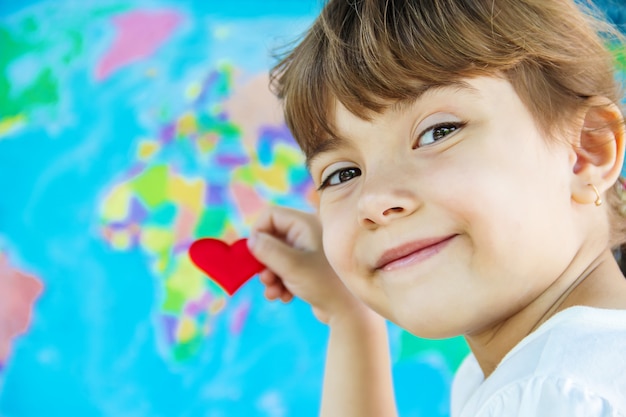 Enfant sur le fond de la carte du monde. Aime voyager. Mise au point sélective.