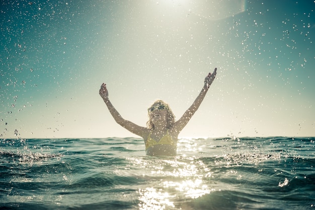 enfant heureux jouant dans la mer