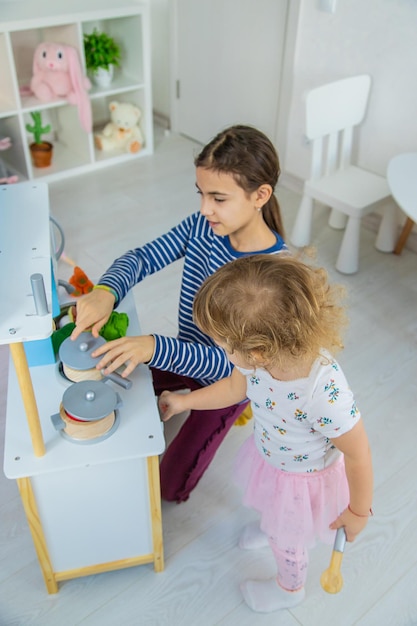 L'enfant joue dans la cuisine et cuisine Mise au point sélective