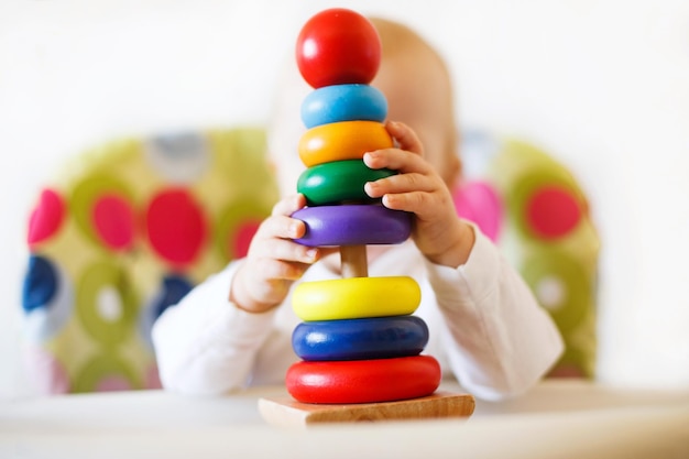 L'enfant joue la pyramide enfant jouant avec des jouets en bois