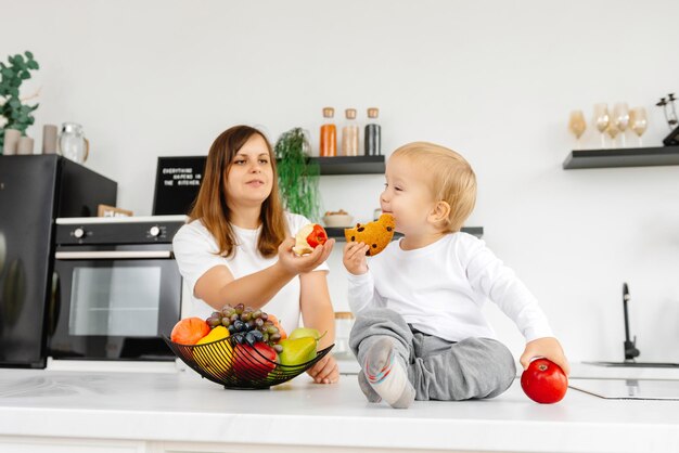 Un enfant mange des biscuits et refuse de bien manger et de manger une alimentation saine en profitant de la plante foo