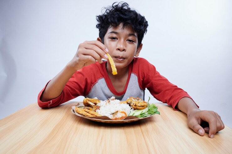 Photo un enfant mange du poulet frit et du riz pour le déjeuner.