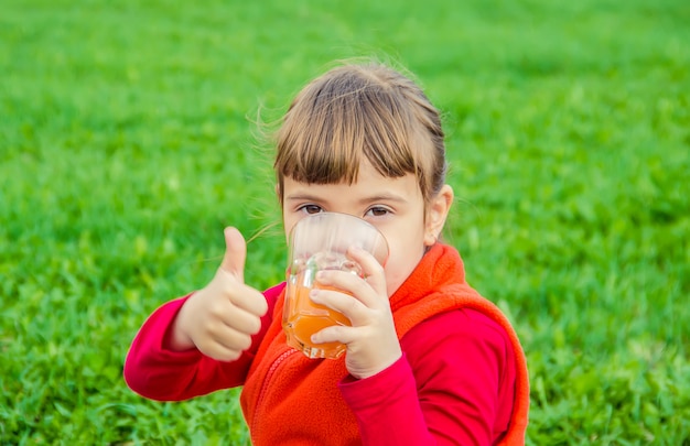 Enfant sur un pique-nique avec jus et fruits. Mise au point sélective.