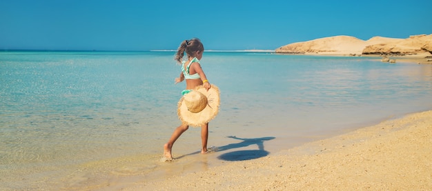 Un enfant sur la plage près de la mer.