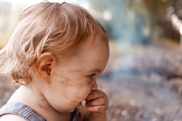 enfant en robe grise dans un pré