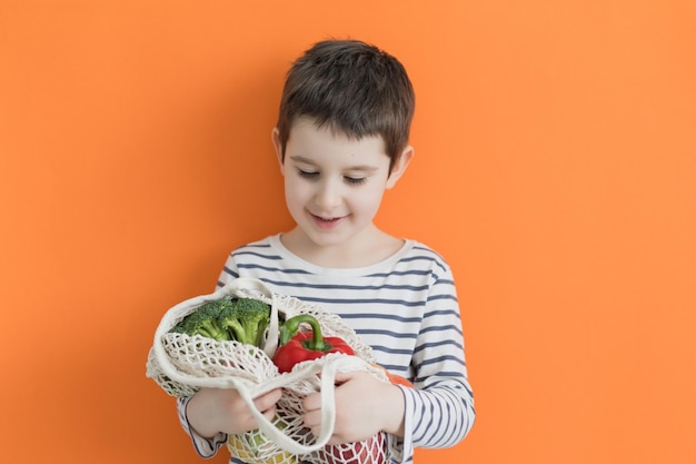 Enfant avec sac écologique avec légumes