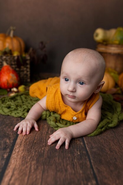 Photo l'enfant se trouve dans la décoration d'automne nouveau-né garçon bébé première séance photo