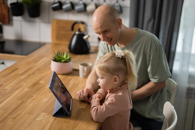 Enfant sourd avec implant cochléaire d'aide auditive s'amuser avec les parents entendre l'aide et la médecine innovante te