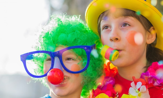 Enfants drôle de carnaval souriant et jouant en plein air