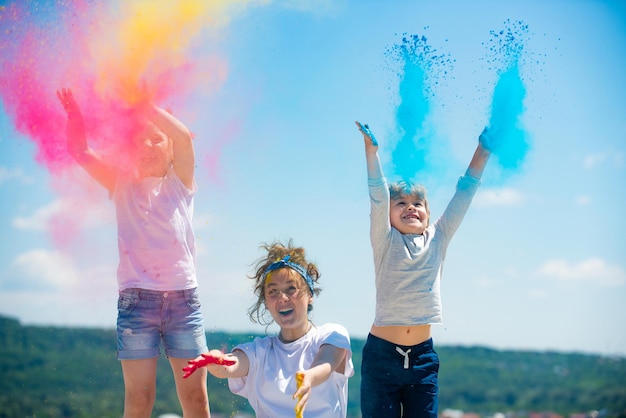 Enfants excités peints aux couleurs des enfants du festival holi éclaboussant de la peinture colorée