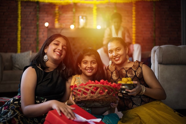 Enfants indiens célébrant Diwali, Deepawali, Bhai Dooj ou Rakhi ou Raksha Bandhan avec rangoli de fleurs, cadeaux, diya