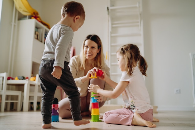 enfants jouant avec la mère dans la salle de jeux