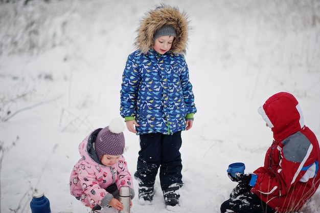 Les enfants à la journée d'hiver boivent du thé chaud.