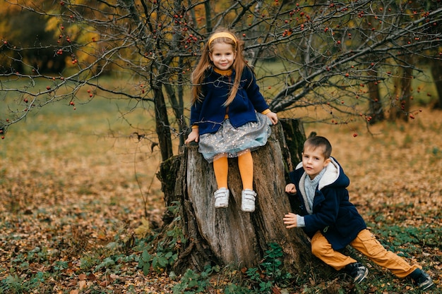 Enfants posant dans le parc d'automne