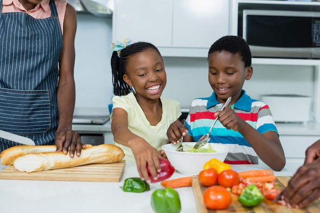 Enfants, préparer, salade, quoique, mère, couper, miche pain, dans, cuisine