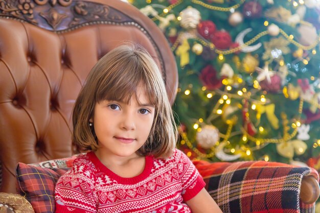 Enfants près de l'arbre de Noël. Mise au point sélective.