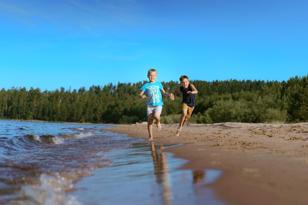 Les enfants qui courent seuls côté forêt de pins esa sur fond concept d'enfance heureuse