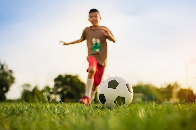 enfants s'amusant à jouer au football pour faire de l'exercice