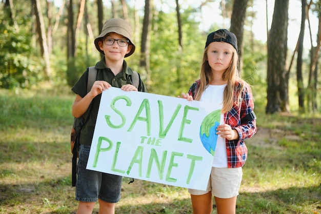 Photo les enfants tiennent une affiche sauvons la planète jour de la terre sauvons la planète de la pollution