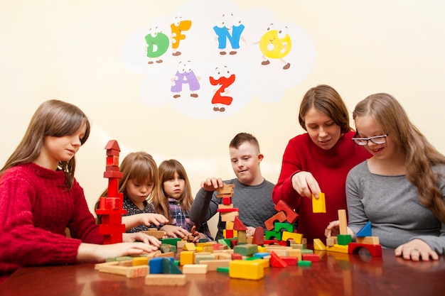 Photo enfants trisomiques jouant avec des blocs colorés