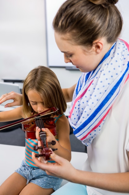 Enseignant, girl, jouer, violon, tableau blanc, classe