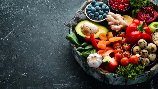 Ensemble d'aliments sains dans une boîte en bois légumes fruits poisson viande noix et herbes Vue de dessus Espace de copie gratuit