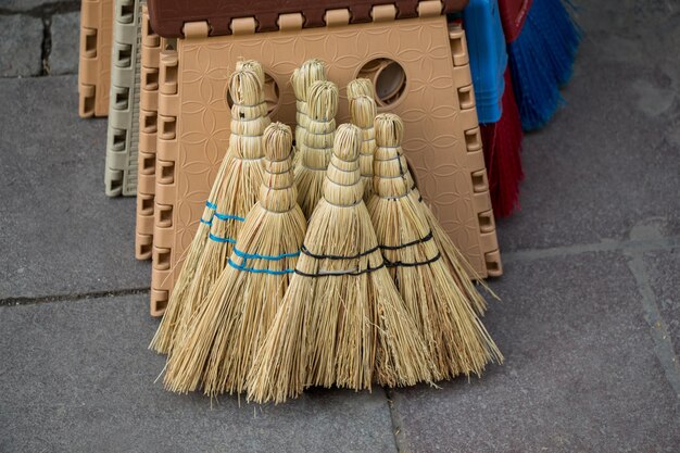 Un ensemble de balai de paille jaune dans le bazar