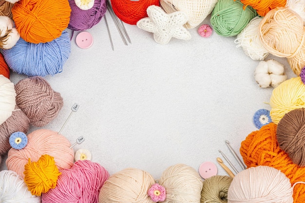 Un ensemble de fils colorés pour le tricot et les outils d'artisanat spéciaux Concept de crochet de passe-temps fait à la main Accessoires et objets sur fond de béton de pierre claire vue de dessus