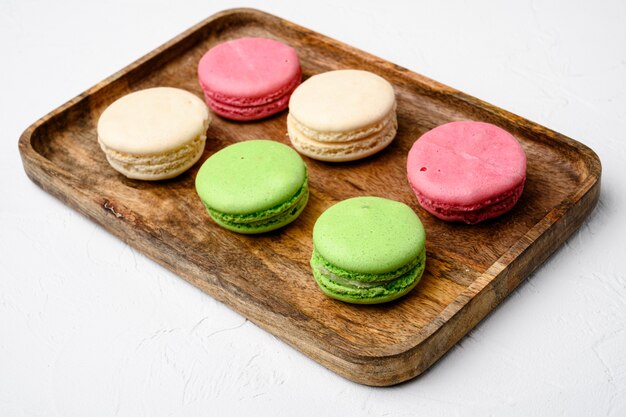 Ensemble de macarons colorés faits maison, sur fond de table en pierre blanche