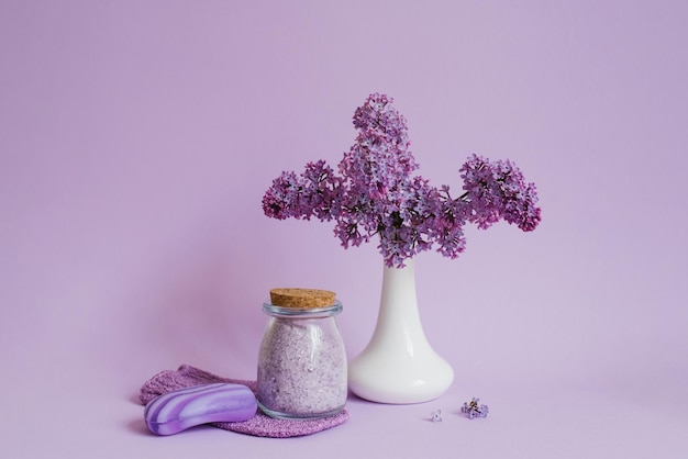 Ensemble de spa relaxant à l'arôme de lilas Savon naturel au sel de mer et fleurs dans un vase blanc sur fond violet