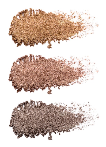 Ensemble de traits d'ombre à paupières en bronze isolés sur fond blanc Gros plan d'un produit de maquillage