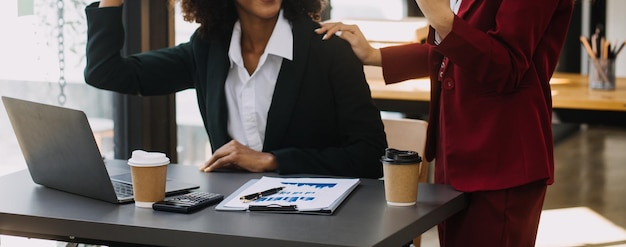 Entrepreneur Un homme d'affaires et une femme d'affaires asiatiques discutent d'un nouveau projet d'affaires sur une tablette dans un bureau moderne.